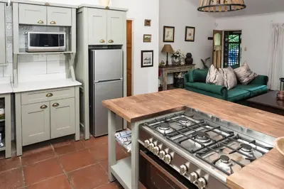a kitchen with a stove top oven in a kitchen at Willow Cottage in Dullstroom
