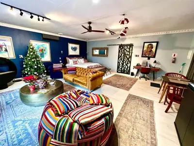 a living room with a christmas tree in the middle of it at Forty 4 On Hoog in Polokwane