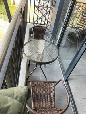 a table and two chairs on a balcony at Mall of Africa Spot By Damo in Midrand