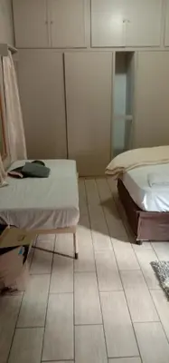 a room with two beds and a tiled floor at Thully Teams in Nelspruit