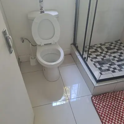 a bathroom with a toilet and a shower stall at Moonlight Guesthouse in Pretoria