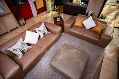 an overhead view of a living room with two brown couches at Pecanwood Lake View in Hartbeespoort