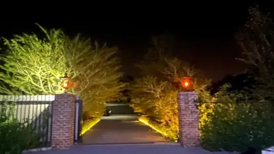 a driveway with a gate and trees at night at Soul Oasis Urban Retreat in Centurion