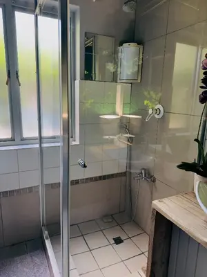 a shower with a glass door in a bathroom at Soul Oasis Urban Retreat in Centurion