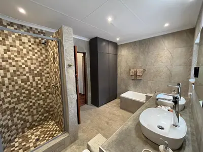a bathroom with a sink and a shower at MILIMA Big 5 Safari Lodge in Hoedspruit