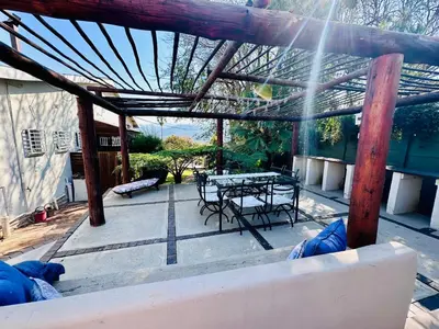 a patio with a table and a picnic table at 49onMain Self Catering Holiday Home in Sabie