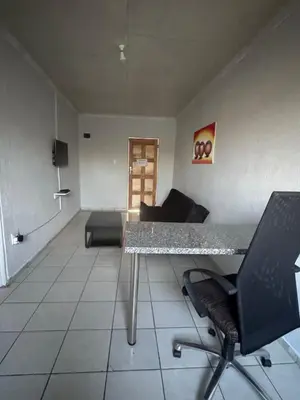 a living room with a table and a couch at RCB guesthouse in Burgersfort