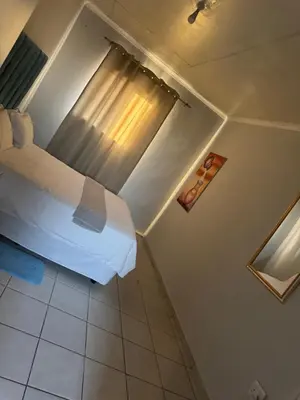 a bedroom with a bed and a window in a room at RCB guesthouse in Burgersfort