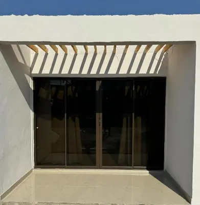 a glass door in a building with a white awning at RCB guesthouse in Burgersfort