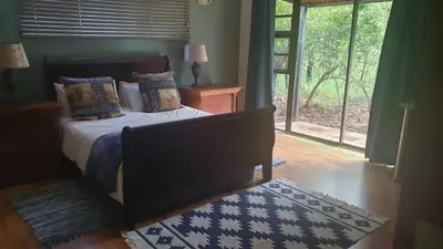 a bedroom with a bed and a large window at 113 Zwartkloof Private Game Reserve Bela-Bela in Bela-Bela