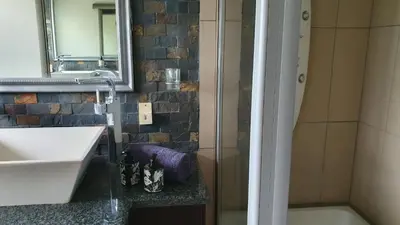 a bathroom with a sink and a shower at 113 Zwartkloof Private Game Reserve Bela-Bela in Bela-Bela