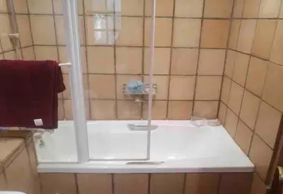 a shower with a glass door in a bathroom at Vintage Serene Villa in Hartbeespoort
