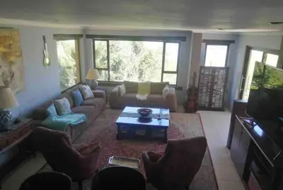 a living room with a couch and a table at Vintage Serene Villa in Hartbeespoort