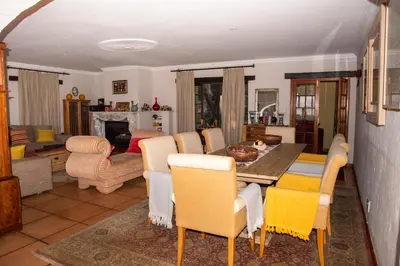 a living room with a table and chairs at Vintage Serene Villa in Hartbeespoort