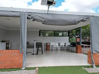 awning over a patio with a table and chairs at Mafini Villa in Centurion
