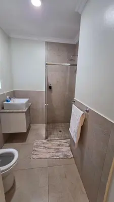 a bathroom with a shower with a toilet and a sink at Mafini Villa in Centurion