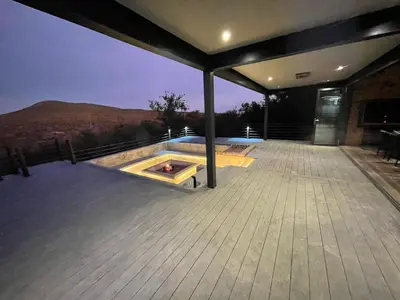 a deck with a fire pit on top of a house at Tadima Lodge Mabalingwe in Mabula
