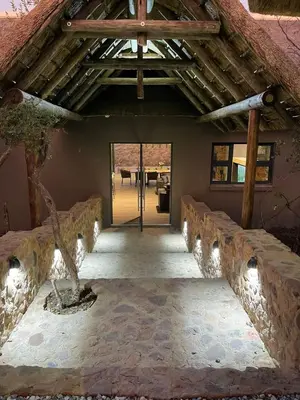 an entrance to a house with a wooden roof at Tadima Lodge Mabalingwe in Mabula