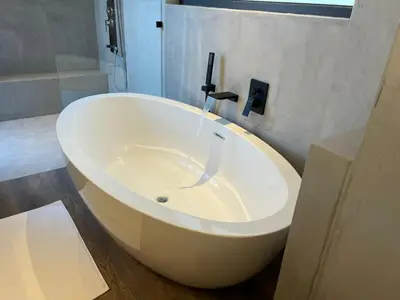 a bath tub with a faucet in a bathroom at Tadima Lodge Mabalingwe in Mabula