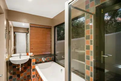 a bathroom with a tub and a sink and a shower at Elements Private Golf Reserve House 296 in Bela-Bela