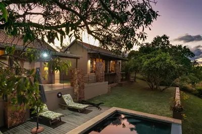 a house with a deck and a swimming pool at Elements Private Golf Reserve House 296 in Bela-Bela