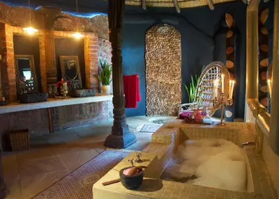 a large room with a bath tub in the middle of a room at Timamoon Lodge in Hazyview