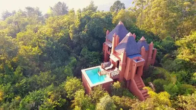 an aerial view of a castle with a swimming pool at Timamoon Lodge in Hazyview