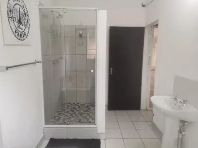 a bathroom with a shower and a sink at The Calm Views Holiday Home in Hazyview