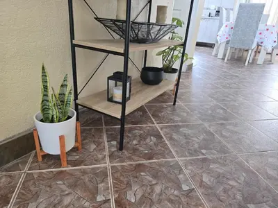 a tiled floor with shelves with plants on it at The Calm Views Holiday Home in Hazyview