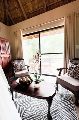 a living room with a coffee table and a couch at Baluleni Safari Lodge in Grietjie Nature Reserve