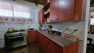 a kitchen with wooden cabinets and a stove top oven at Northwich Game Ranch in Louis Trichardt