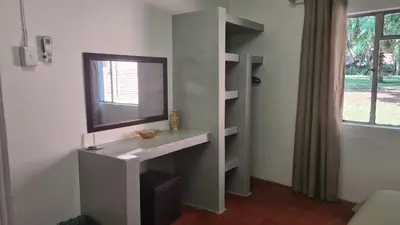 a bathroom with a sink and a mirror and a window at Northwich Game Ranch in Louis Trichardt