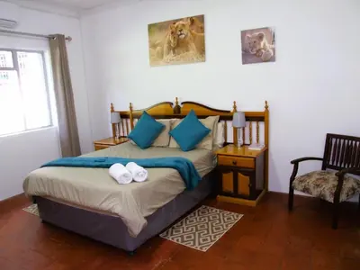 a bedroom with a bed with two towels on it at Northwich Game Ranch in Louis Trichardt