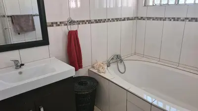 a white bathroom with a tub and a sink at Northwich Game Ranch in Louis Trichardt