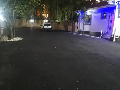 a car parked in a parking lot at night at Munach Guest Lodge in Benoni