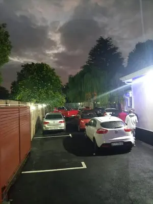 a group of cars parked in a parking lot at Munach Guest Lodge in Benoni