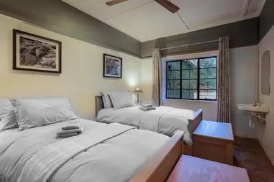 a bedroom with two beds and a window at The Stone House in Die Winkler