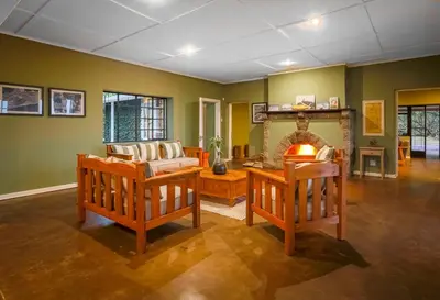 a living room with a couch and a fireplace at The Stone House in Die Winkler
