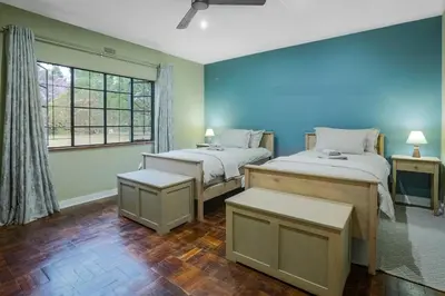 a bedroom with two beds and a window at The Stone House in Die Winkler