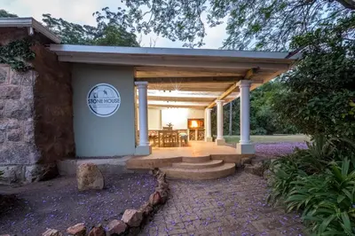 a pavilion with a table and chairs on a patio at The Stone House in Die Winkler