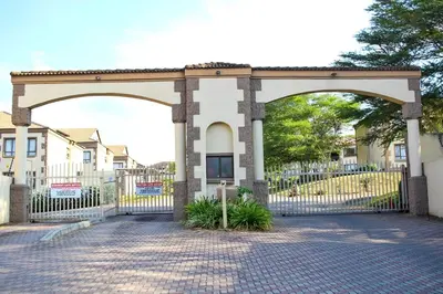 a gate with an arch in front of a building at Mills Pad with 2-bedroom in Nelspruit