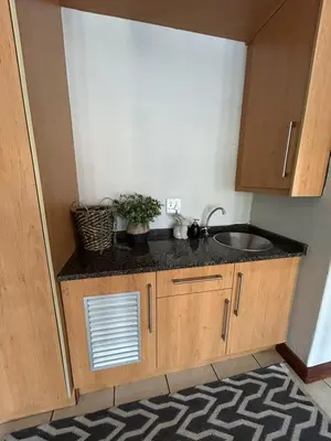 a small kitchen with a sink and a counter at Fish Eagle Bay 28, Warmbaths in Bela-Bela