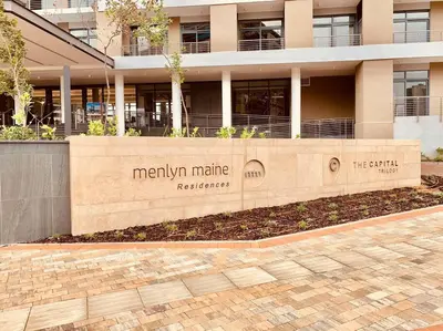 a sign in front of a building at Menlyn Maine High Rise 1-Bedroom Luxury Apartment in Pretoria