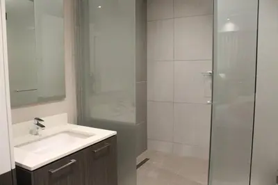 a bathroom with a sink and a shower at Menlyn Maine High Rise 1-Bedroom Luxury Apartment in Pretoria