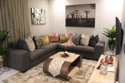 a living room with a couch and a table at Menlyn Maine High Rise 1-Bedroom Luxury Apartment in Pretoria