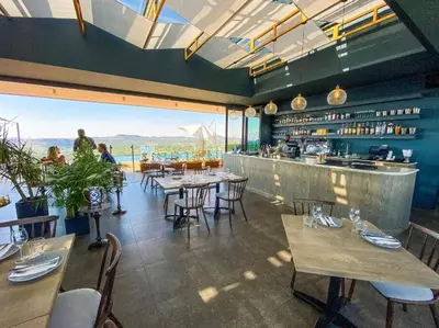 a restaurant with tables and chairs and a bar at Menlyn Maine High Rise 1-Bedroom Luxury Apartment in Pretoria