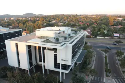 an aerial view of a building with a parking lot at Menlyn Maine High Rise 1-Bedroom Luxury Apartment in Pretoria