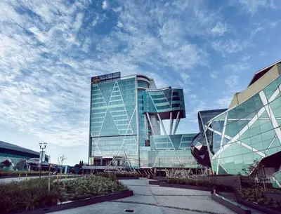 a large glass building with a sky at Menlyn Maine High Rise 1-Bedroom Luxury Apartment in Pretoria