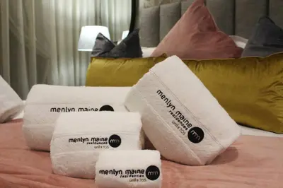 a pile of towels on top of a bed at Menlyn Maine High Rise 1-Bedroom Luxury Apartment in Pretoria