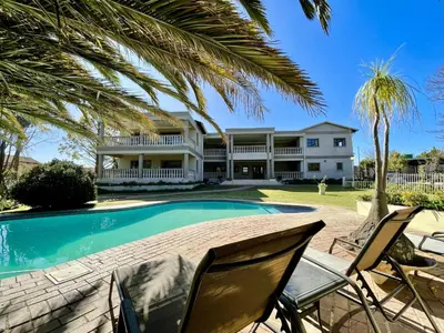 an exterior view of a house with a swimming pool at Palm View Midrand Guest House in Midrand